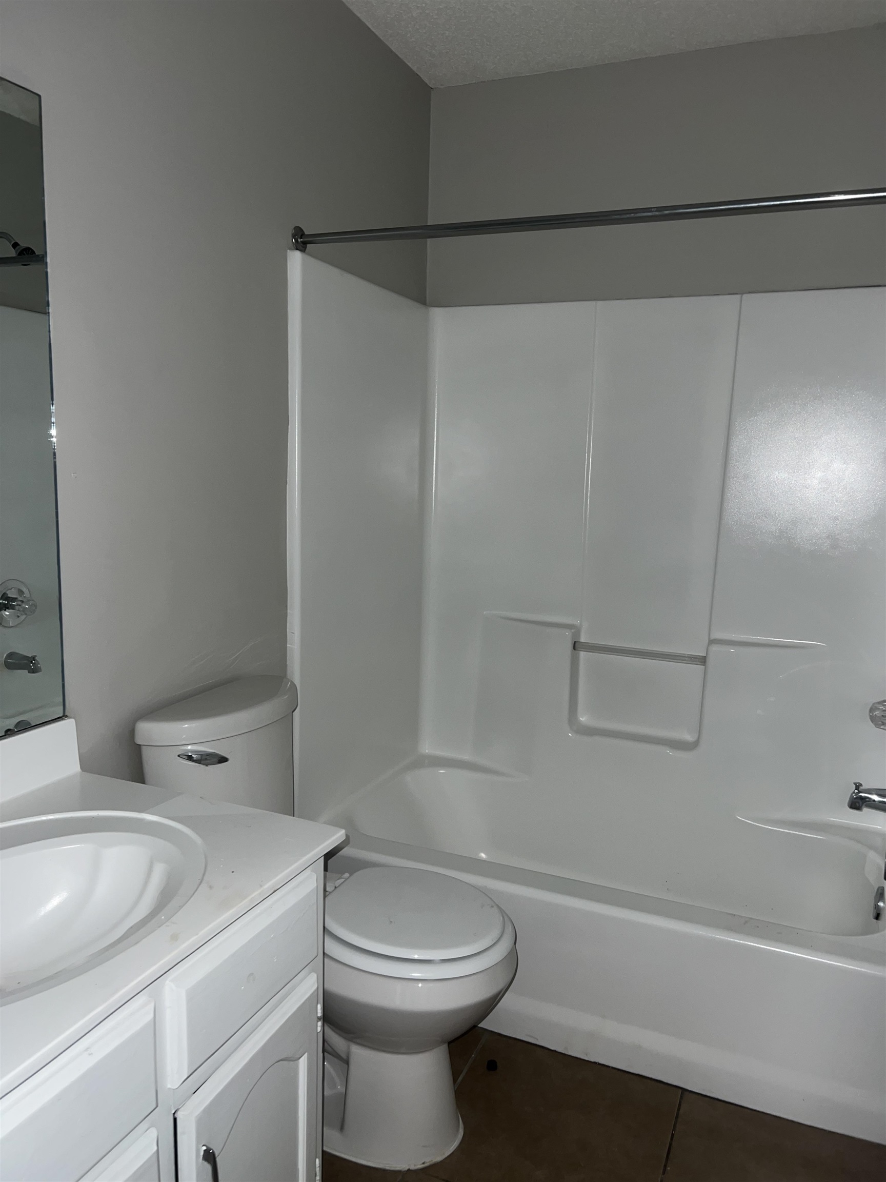 4609 Crestfield Road Millington, TN 38053 - Photo 8 of 8 Full bathroom featuring vanity, bathtub / shower combination, tile patterned flooring, toilet, and a textured ceiling