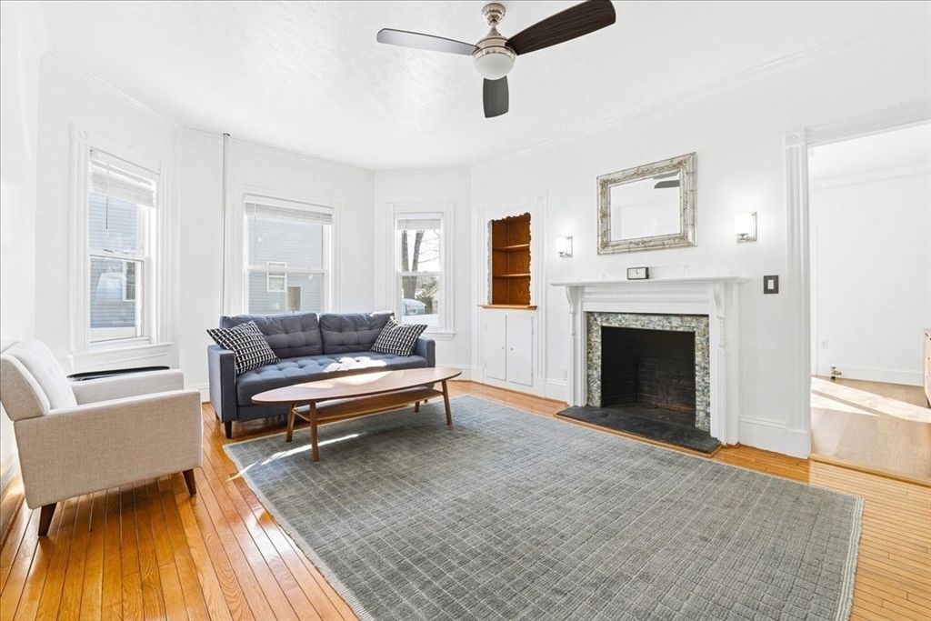 73 Hudson Street Milton, MA 02186 - Photo 12 of 42 a living room with furniture and a fireplace