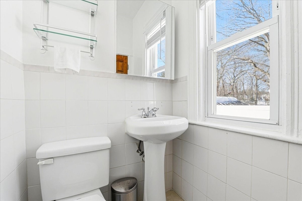73 Hudson Street Milton, MA 02186 - Photo 16 of 42 a bathroom with a sink a toilet and a window
