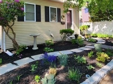 73 Hudson Street Milton, MA 02186 - Photo 2 of 42 a front view of a house with a yard and potted plants