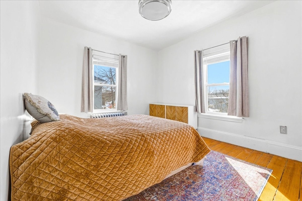 73 Hudson Street Milton, MA 02186 - Photo 22 of 42 a bed sitting in a bedroom next to a window