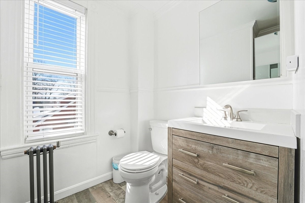 73 Hudson Street Milton, MA 02186 - Photo 27 of 42 a bathroom with a sink a toilet and a window