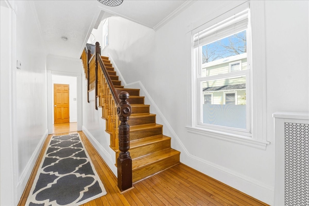 73 Hudson Street Milton, MA 02186 - Photo 5 of 42 a view of an entryway with wooden floor