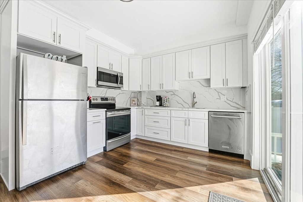 73 Hudson Street Milton, MA 02186 - Photo 6 of 42 a kitchen with white cabinets and white appliances