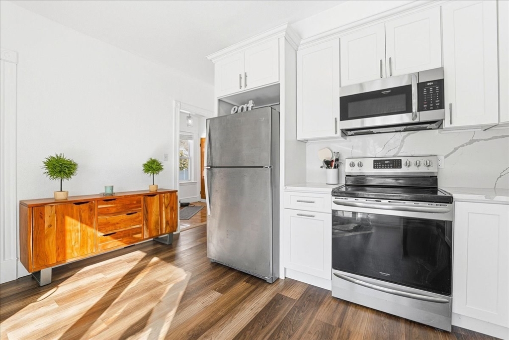 73 Hudson Street Milton, MA 02186 - Photo 8 of 42 a kitchen with stainless steel appliances a stove microwave and refrigerator