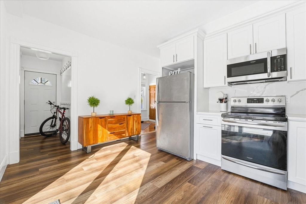 73 Hudson Street Milton, MA 02186 - Photo 9 of 42 a kitchen with stainless steel appliances a stove a microwave and a refrigerator