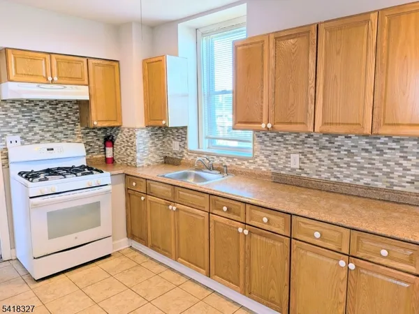 a kitchen with stainless steel appliances a stove sink and cabinets