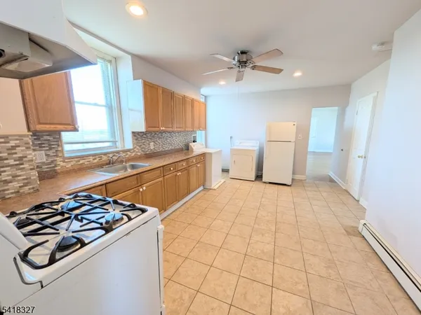 a kitchen with a stove a sink and a refrigerator