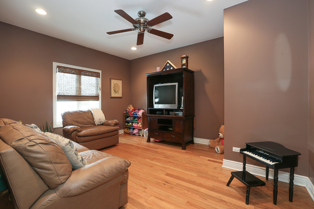 248 Highland Road Willowbrook, IL 60527 - Photo 12 of 25 a living room with furniture a ceiling fan a rug and a window
