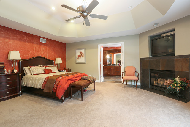 248 Highland Road Willowbrook, IL 60527 - Photo 14 of 25 a spacious bedroom with a bed and a fireplace