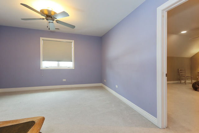 248 Highland Road Willowbrook, IL 60527 - Photo 17 of 25 a view of a livingroom with a window and a chandelier fan