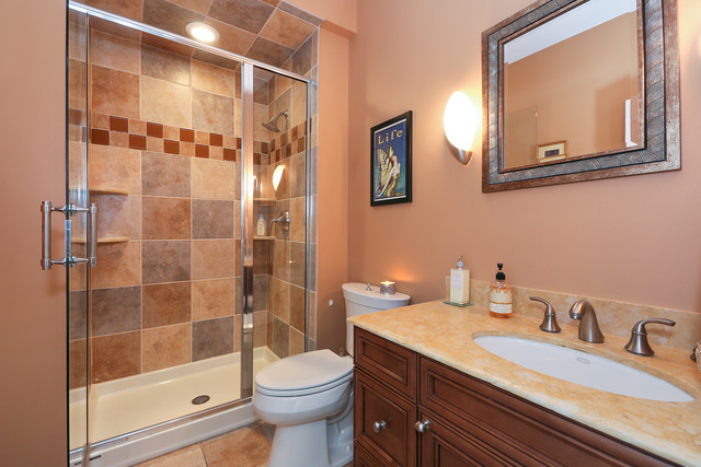 248 Highland Road Willowbrook, IL 60527 - Photo 20 of 25 a bathroom with a sink a toilet and shower