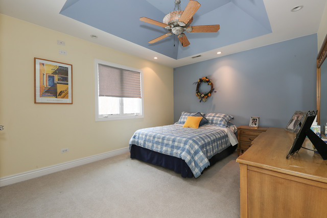 248 Highland Road Willowbrook, IL 60527 - Photo 21 of 25 a bedroom with a bed and a chandelier