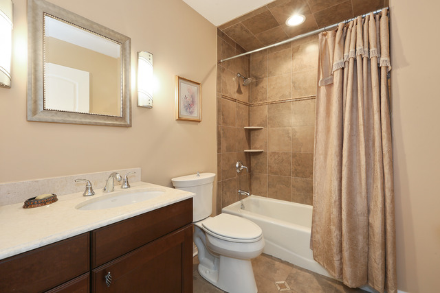 248 Highland Road Willowbrook, IL 60527 - Photo 22 of 25 a bathroom with a sink a toilet and shower