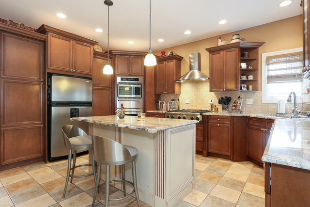 248 Highland Road Willowbrook, IL 60527 - Photo 5 of 25 a kitchen with stainless steel appliances granite countertop a sink a stove and a refrigerator