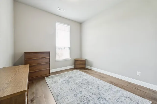 an empty room with a dresser