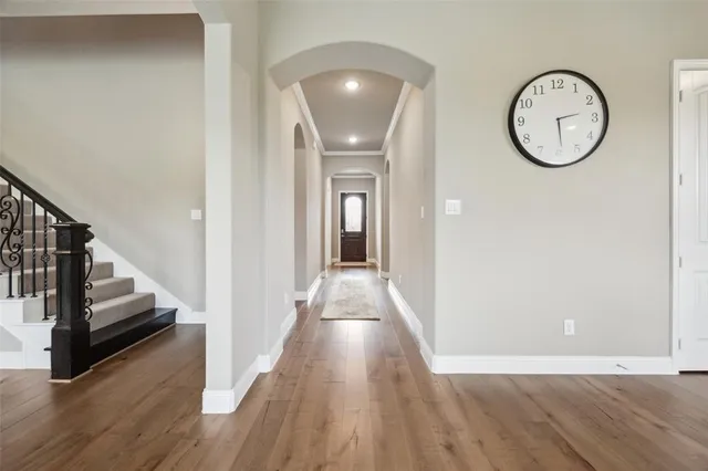 a view of a hallway with wooden floor