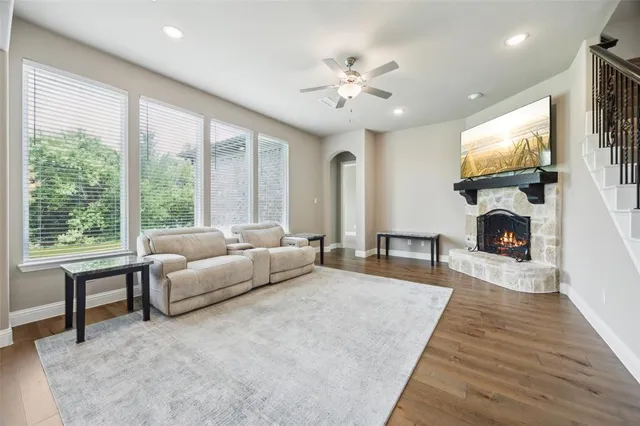 a living room with furniture a large window and a flat screen tv