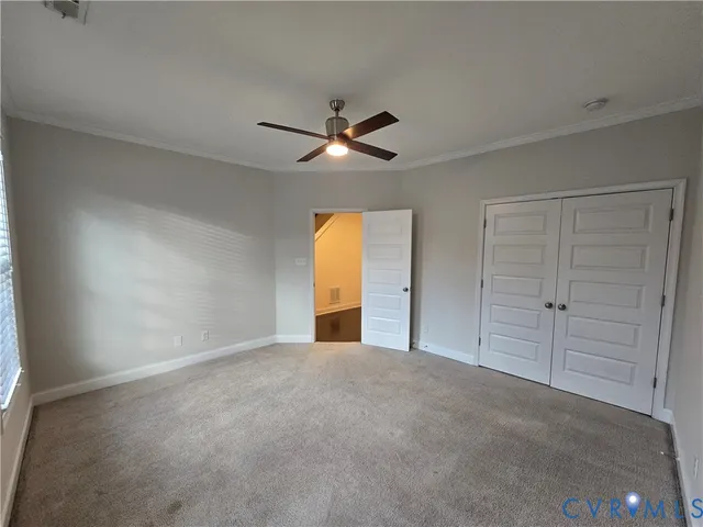 an empty room with fan and fan
