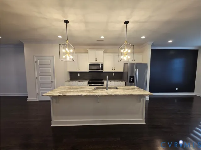a view of kitchen with living room and chandelier