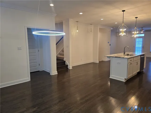 an open kitchen with a sink and dish washer