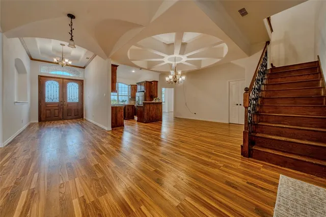 a view of a room with wooden floor and staircase