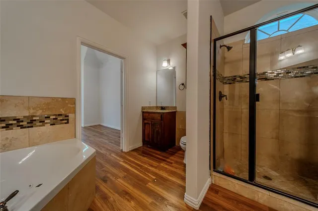 a view of a bathroom with a tub and shower