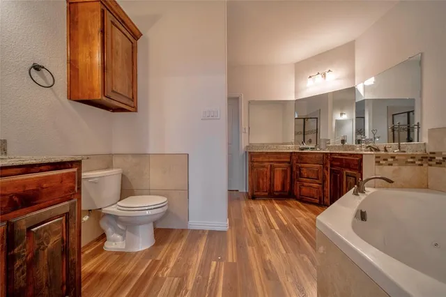 a spacious bathroom with a sink a toilet and bathtub