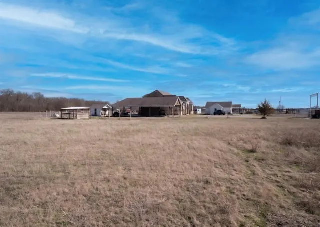 a view of a road with a white house