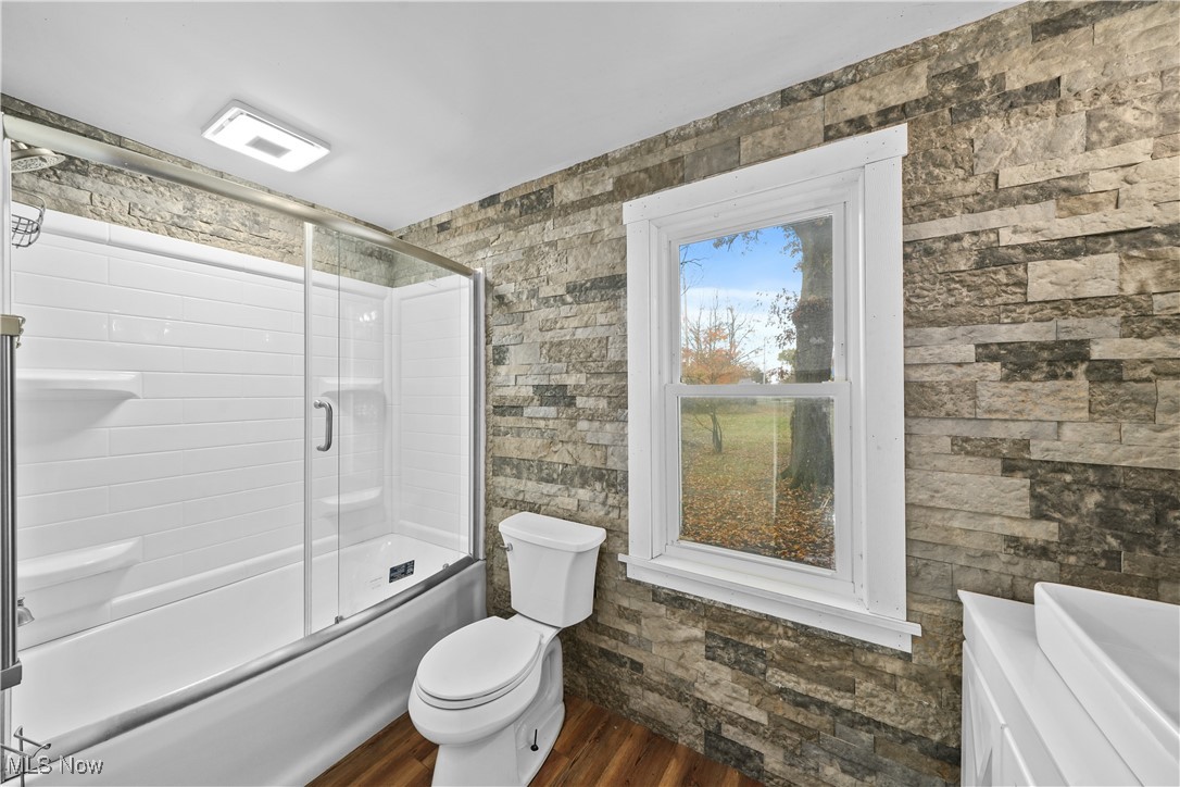 14080 Nash Road Burton, OH 44021 - Photo 12 of 49 Full bathroom featuring vanity, toilet, shower / bath combination with glass door, and hardwood / wood-style floors