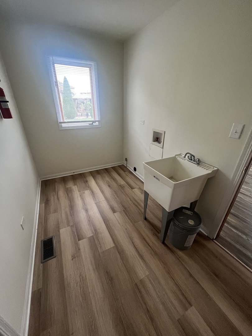 22073 Spring Lane Richton Park, IL 60471 - Photo 24 of 30 a room with wooden floor and furniture