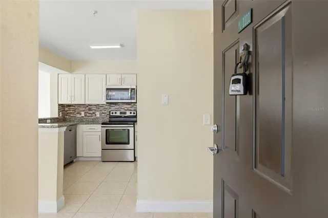 a kitchen with a refrigerator and a stove top oven