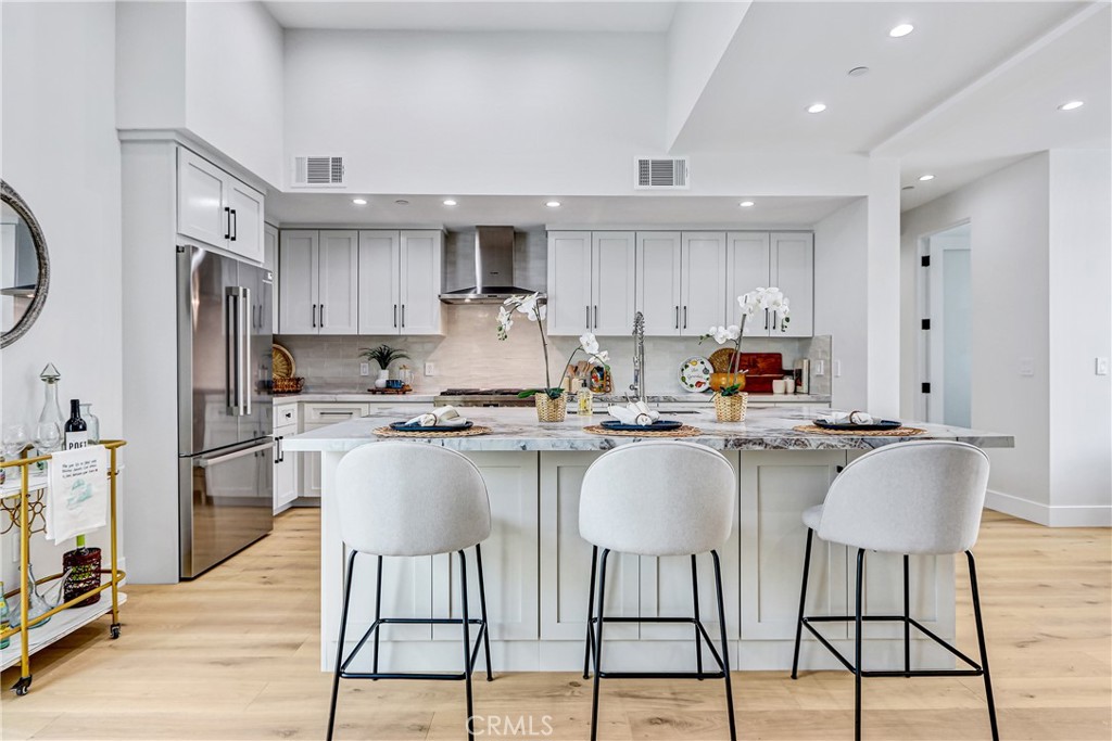 2405 Mathews Avenue, Unit B Redondo Beach, CA 90278 - Photo 1 of 46 a kitchen with stainless steel appliances granite countertop a stove a sink a refrigerator and white cabinets with wooden floor