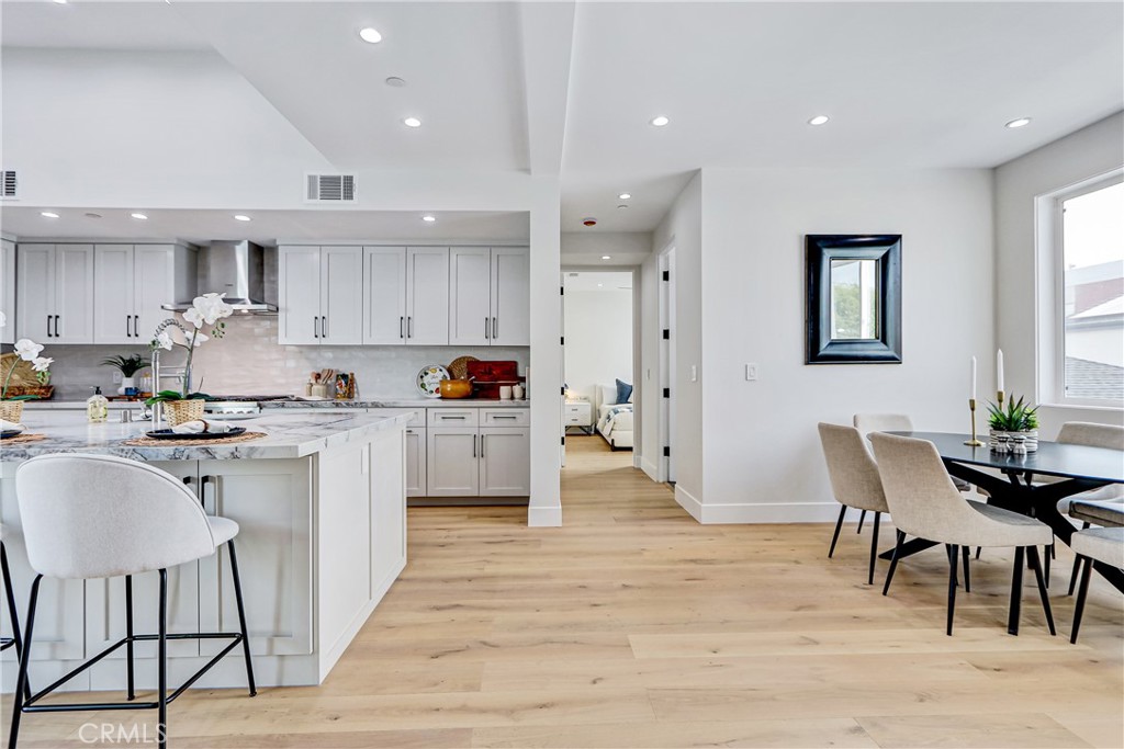 2405 Mathews Avenue, Unit B Redondo Beach, CA 90278 - Photo 16 of 46 a kitchen with white cabinets and chairs