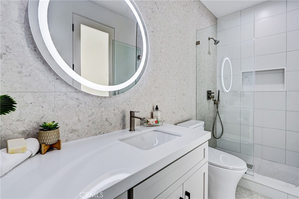 2405 Mathews Avenue, Unit B Redondo Beach, CA 90278 - Photo 40 of 46 a bathroom with a sink a toilet and a mirror