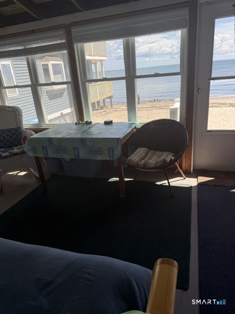 105 Shore Road Clinton, CT 06413 - Photo 7 of 19 East side of the enclosed porch has a seating area and room for a futon or couch.