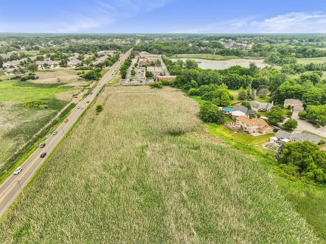 an aerial view of residential houses with outdoor space and swimming pool