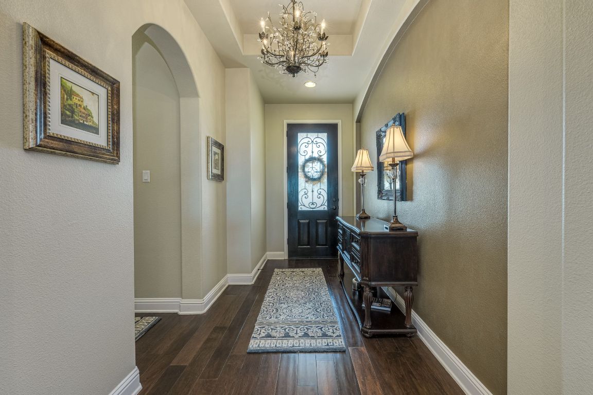 306 Tavish Trail Austin, TX 78738 - Photo 16 of 40 a view of a hallway with wooden floor and a mirror