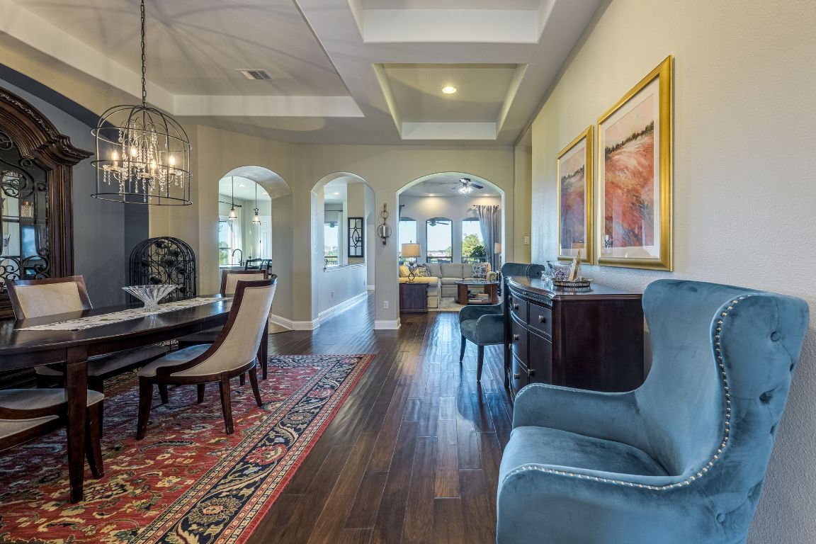 306 Tavish Trail Austin, TX 78738 - Photo 17 of 40 a living room with furniture a chandelier and a large window