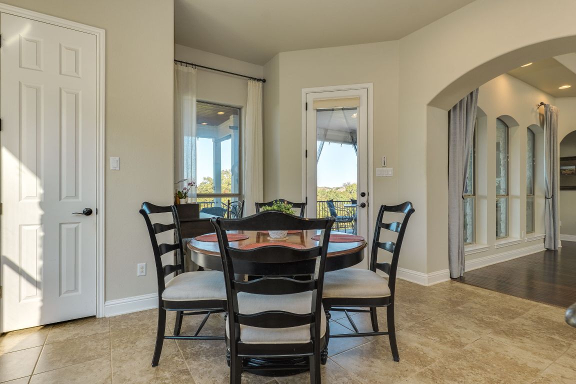 306 Tavish Trail Austin, TX 78738 - Photo 23 of 40 a view of a dining room with furniture and a chandelier