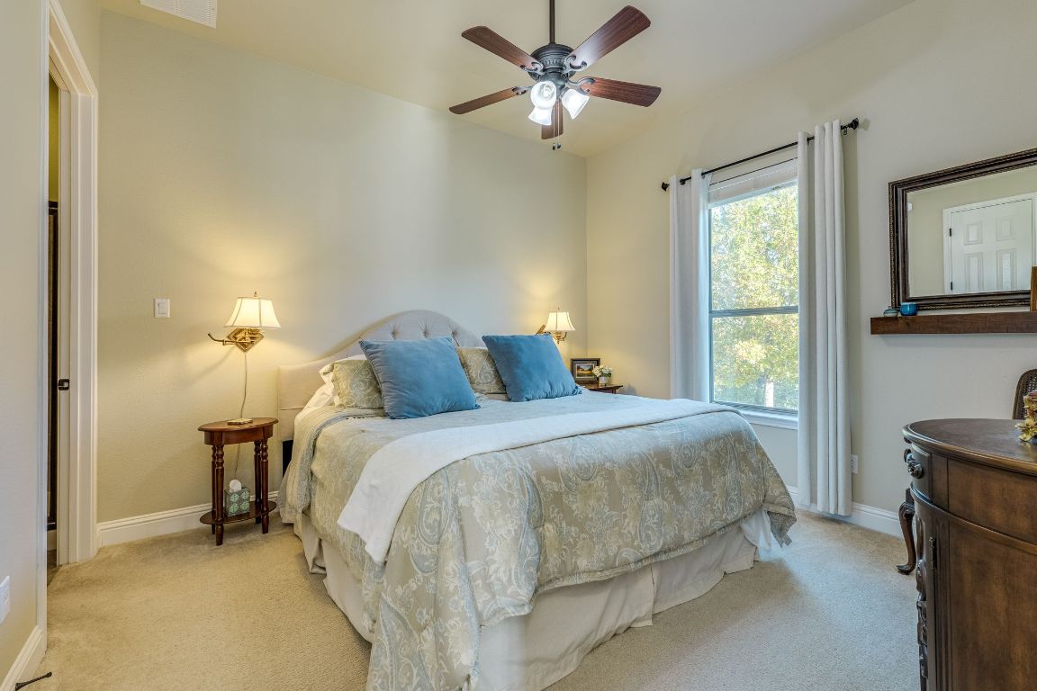306 Tavish Trail Austin, TX 78738 - Photo 32 of 40 a bed room with a bed and a window
