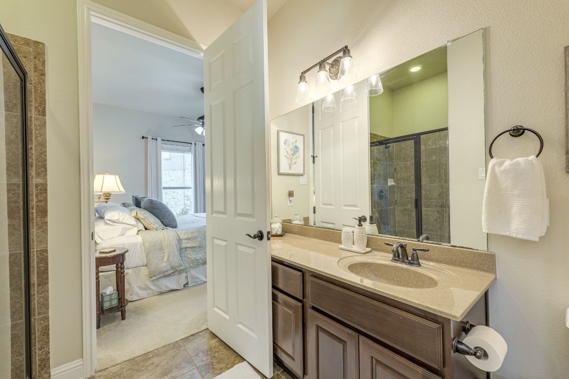 306 Tavish Trail Austin, TX 78738 - Photo 33 of 40 a en suite bathroom with a sink double vanity and a mirror