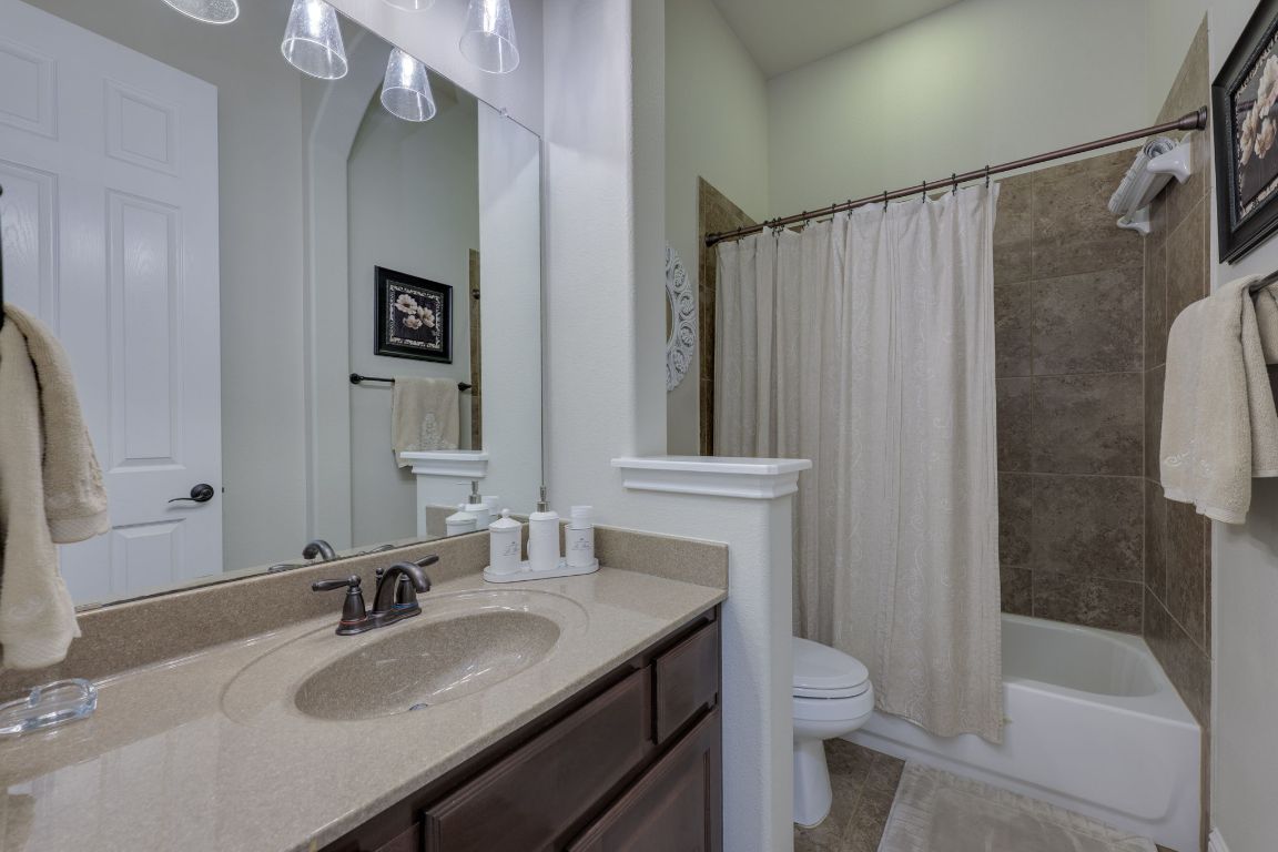 306 Tavish Trail Austin, TX 78738 - Photo 34 of 40 a bathroom with a granite countertop sink toilet and shower