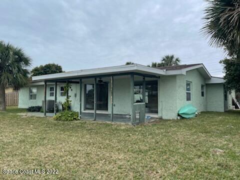 1011 Bali Road Cocoa Beach, FL 32931 - Photo 6 of 6 front view of a house with a yard