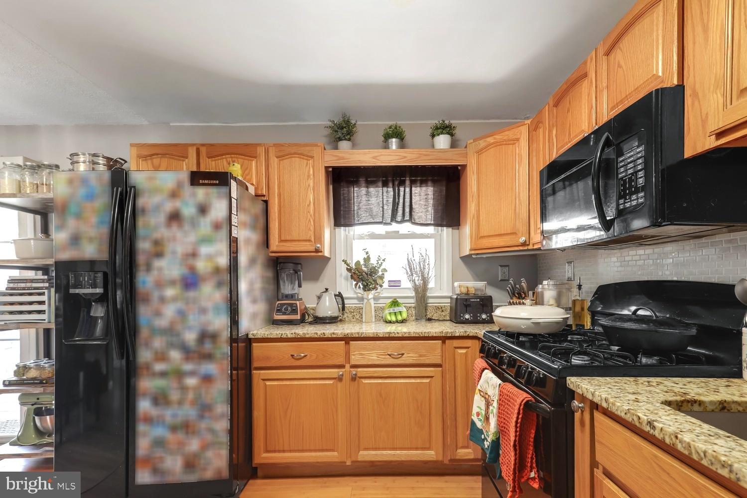 13705 Kerrydale Road Woodbridge, VA 22193 - Photo 12 of 32 a kitchen with stainless steel appliances granite countertop a stove a sink and a refrigerator