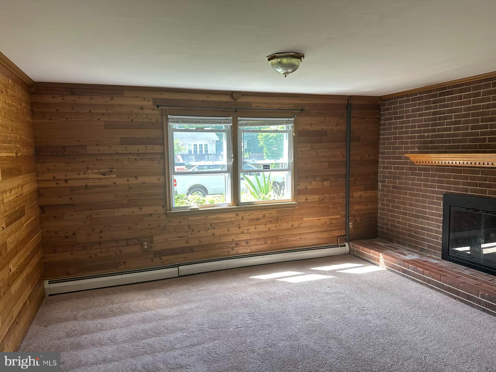 13705 Kerrydale Road Woodbridge, VA 22193 - Photo 21 of 32 a view of an empty room with a fireplace and a window