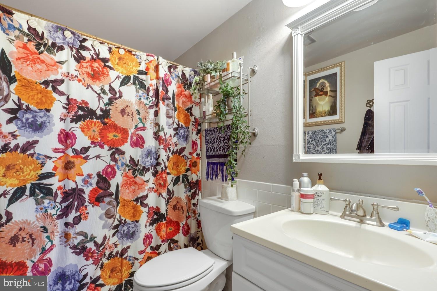 13705 Kerrydale Road Woodbridge, VA 22193 - Photo 23 of 32 a bathroom with a sink mirror vanity and toilet