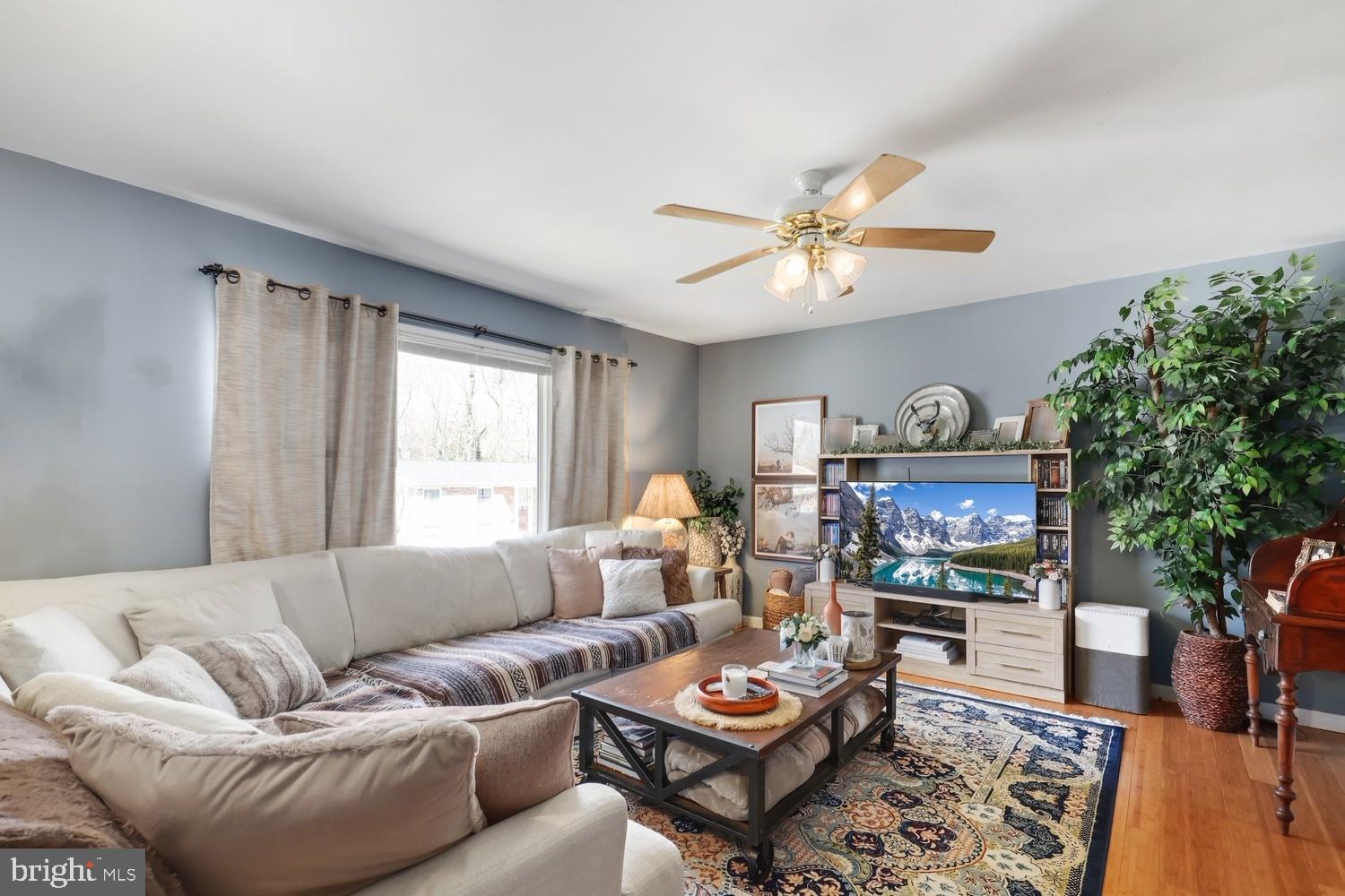 13705 Kerrydale Road Woodbridge, VA 22193 - Photo 6 of 32 a living room with furniture a fireplace and a flat screen tv