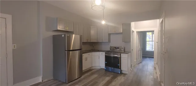 a kitchen with a stove a refrigerator and a sink
