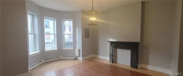 a view of an empty room with glass door and a window